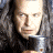 A pixelated promotional image for The Lord of the Rings: The Return of the King featuring a character with long hair and armor, alongside golden text on a brown background.