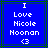 Blue background with white pixelated text reading "I Love Nicole Moonan <3" in four lines, framed by green and dark blue borders.