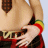 Animated sequence showing a person's torso with hand on hip, wearing red and black plaid skirt, yellow belt, brown tie, and rainbow wristband.