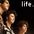 Pixelated image of three people against a dark background with white text reading 'life.' in the top right corner.