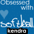 Pixelated blue background with white text reading 'Obsessed with' above a light blue heart, followed by stylized 'soft ideal' and black 'kendro' at the bottom.