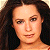 A 50x50 pixel buddy icon split into two frames showing a woman's face on the left and green text on a dark background on the right, with visible pixelation and dithering effects.