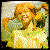 pixelated images showing a person with red hair in pigtails, wearing a light-colored top and green background, transitioning through color variations