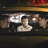 Animated sequence showing a shirtless person between two uniformed officers in different settings with "McLovin" text at bottom.