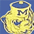 Yellow ceramic mug with blue interior and handle, featuring a large black 'M' on the front, set against a solid blue background.