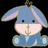 Pixelated cartoon character with light blue body, pink inner ears, and black square eyes against a solid black background.