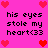 Pixelated pink background with repeated black text 'his eyes stole my heart<33' and red heart symbols at corners and center.