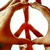 Red peace sign symbol centered within a circular frame with light brown border, displayed in a with four identical copies