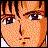 Pixelated close-up of a person's face with light brown hair, dark eyes, and a neutral expression against a warm-toned background.