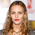 A pixelated close-up of a person with long brown hair, red lips, and closed eyes against a light background with faint red and yellow shapes.