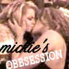 Two women with light brown hair embrace closely, one kissing the other's cheek, with overlaid text reading "mickle's OBSESSION" in black and white fonts.