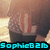 Pixelated image of a person with light brown hair and dark clothing, featuring cyan text at the bottom reading "SophieB216".