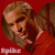 Pixelated image of a person with light brown hair and fair skin, wearing red clothing against a solid red background.