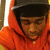 A person in an orange hoodie and black cap appears in three with subtle head position changes