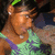 A person wearing a green and purple patterned top with a green headband, shown in three sequential poses.