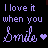 Animated text repeats 'I love it when you Smiles' with purple hearts, cycling through color variations on a black background.