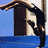 Animated sequence of a figure diving into water from a tiled roof structure against a blue sky.