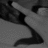 Black-and-white animated icon showing a hand holding a long object with dark curved shapes below it, transitioning from left to right across frames.