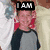 A pixelated image shows a person with light hair wearing a gray and dark blue raglan shirt, next to an animated robot labeled 'Optimus Prime' in bold text.