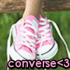 A close-up of a foot wearing pink and white striped sneakers on green grass with a wooden surface in the background, featuring text overlay at the bottom.