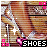 Pixelated image of legs in high-heeled shoes with pink accents, white sparkles, and the word 'SHOES' at bottom.