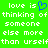 Green background with white pixelated text reading 'love is thinking of someone else more than urself' and a blue heart symbol replacing the letter 'o' in 'love'.