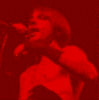six color-filtered band member images in red, orange, yellow, green, blue, and purple hues with one empty gray