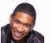 A person in a dark jacket smiles against a white background with red text and symbols appearing sequentially.