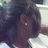 A person with dark hair and a small earring wears a white shirt, viewed from the side in three showing slight head movement