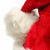 Red and white Santa hat with fluffy trim, showing partial view of the hat's brim and crown against a plain background.