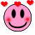 A 4x4 contact sheet of animated pink smiley face icons with red hearts, each frame showing different heart positions and facial expressions.