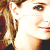 Pixelated close-up of two people's faces in profile view with visible hair, eyes, and lips against a white background.