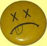 Static circular yellow cartoon face with X eyes, downturned mouth, and tongue sticking out on a pale yellow background.