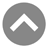 Gray circular icon with white border containing white upward-pointing chevron symbol on solid gray background.