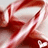 Abstract red and white pixelated pattern with flowing curved shapes against a light gray background.