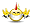 Yellow spherical character with red and green antenna, closed eyes, silver mouth covering, yellow hands raised in peace sign on sides.