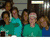 Group of people in teal shirts and blue background with a horse image below, text "i love to ride!" at bottom.