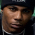 Two side-by-side pixelated faces with distinct skin tones, one wearing a dark beanie and white necklace, the other in light-toned clothing against blurred green background.