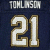 A football player wearing a blue jersey with number 21 and name TOMLINSON on the back, holding a football in motion.
