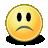 Pixelated yellow circular face with black eyes and downturned mouth on dark base, static image.