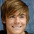 Pixelated portrait of a person with light brown hair and a neutral expression against a blue background.