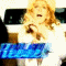 A woman with curly blonde hair appears in multiple poses holding a small object, with blue text reading 'Rebel' below her.