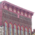 A pixelated image of a building with a red roof and multiple columns, viewed from a low angle against a white background.