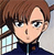 Pixelated cartoon-style icon of a person with brown hair, light skin, and dark eyes wearing a dark blue zip-up jacket over a light shirt.