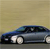 Static pixelated image of a dark blue sedan with white headlights against a beige background.