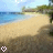 Animated beach scene with shifting sand shadows and water reflections under a light blue sky.