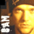 Static pixelated icon featuring a golden-yellow face with closed eyes and visible facial features against a dark brown background, with white vertical text on the left side.