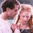 Two people in a close-up pose on the left, green background with pixelated text on the right.