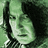 Pixelated green-tinted image of a person with long dark hair and striped shirt, split into two with text overlays