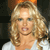 A static pixelated image of a person with long wavy blonde hair wearing a white top against a dark background with an orange element at the top.